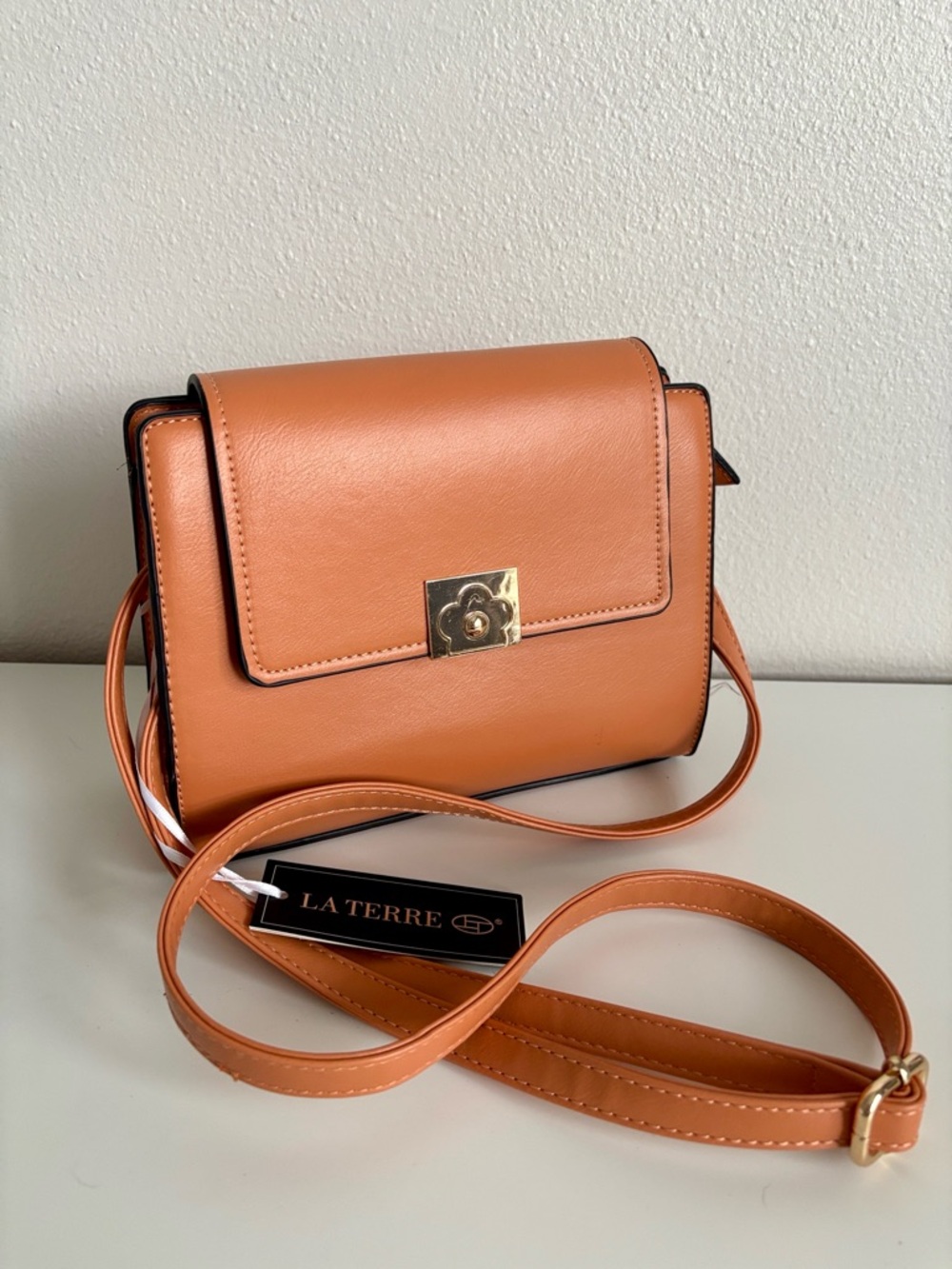 NWT La Terre orange sling bag gold-toned clasp adjustable shoulder strap leather